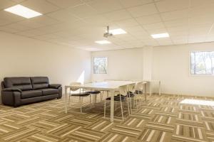 an office with a table and chairs and a couch at L'ilot Narossais - Conciergerieland in Narrosse