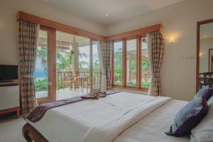 a bedroom with a large bed and a balcony at Villa Le Tito in Lovina +109 photos