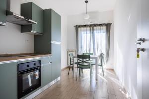 a kitchen and dining room with a table and chairs at I Tigli in Valmontone