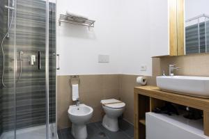 a bathroom with a toilet and a sink and a shower at I Tigli in Valmontone
