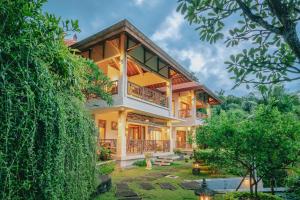 a house in the middle of a forest at Villa Le Tito in Lovina