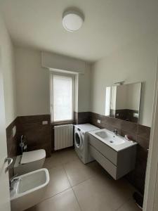 a bathroom with a sink and a washing machine at Manzoni in Esine
