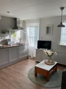 a kitchen with a table in the middle of a room at B&B De Singel in Medemblik