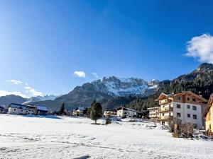 a village in the snow with mountains in the background at Apartment Cristina by Interhome in Campestrin +31 photos