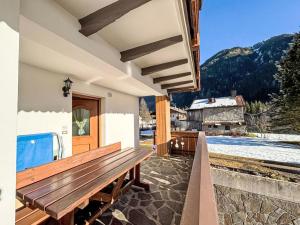 a wooden bench sitting on a porch of a house at Apartment Cristina by Interhome in Campestrin