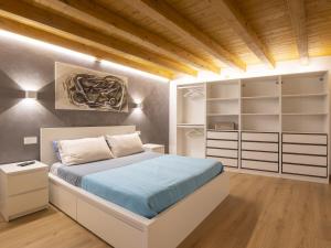 a bedroom with a large bed and shelves at Villa Cech Coast House by Interhome in Civo