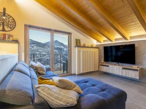a large blue couch in a living room with a large window at Villa Cech Coast House by Interhome in Civo
