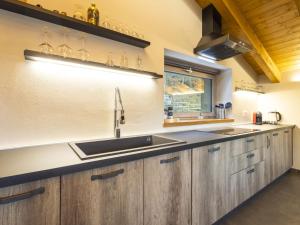a kitchen with wooden cabinets and a sink at Villa Cech Coast House by Interhome in Civo +33 photos