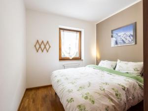 a bedroom with a large bed and a window at Apartment The Silent Sylva by Interhome in Isolaccia