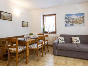 a living room with a table and a couch at Apartment The Silent Sylva by Interhome in Isolaccia