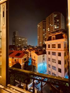 a view of a city at night from a window at Nam Cường X Hotel in Hanoi