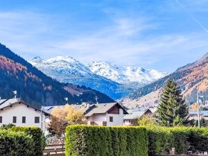 a village with snow capped mountains in the background at Apartment The Silent Sylva by Interhome in Isolaccia