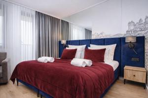 a bedroom with a large bed with towels on it at InPoint Central Apartments Old Town&Kazimierz - Free Parking in Krakow