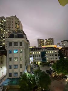 a view of a building in a city at night at Nam Cường X Hotel in Hanoi
