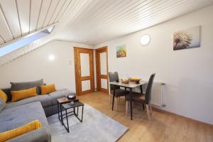 a living room with a couch and a table at Gästehaus Höfler in Bayerisch Gmain