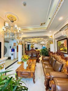 a living room with leather furniture and a table at Nam Cường X Hotel in Hanoi +220 photos