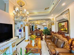 a living room with leather furniture and a tv at Nam Cường X Hotel in Hanoi
