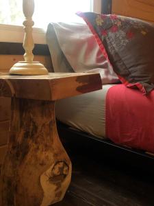 a bed with a wooden side table next to a bed at Funky Bunky in Nelson +25 photos