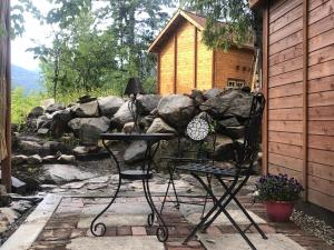 a patio with a table and a chair in front of a building at Funky Bunky in Nelson