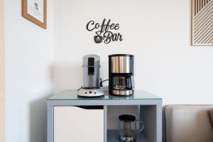 a coffee maker on a table in a room at Solymar Whg 64 in Grömitz