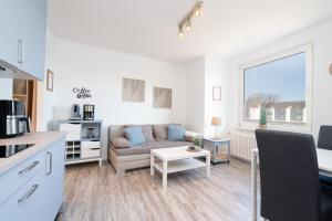 a living room with a couch and a table at Solymar Whg 64 in Grömitz