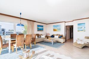 a living room with a table and a dining room at Miramar Whg 513 in Grömitz