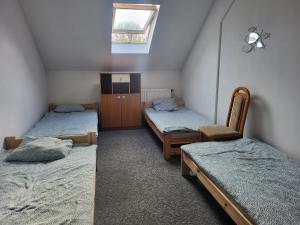 a room with three beds and a window in it at Rent Warszawa Ursynów in Warsaw