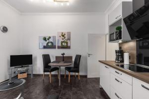 a kitchen with a table and chairs in a kitchen at Solymar Whg 11 in Grömitz