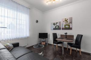 a living room with a couch and a table at Solymar Whg 11 in Grömitz