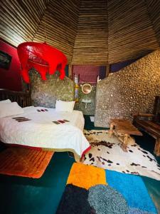 a bedroom with a large bed and a rug at Oldadai Falls Retreat in Arusha