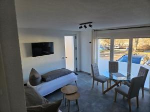 a living room with a couch and a table at Ferienwohnung Zur Alt Ave in Deggingen