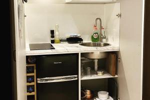 a small kitchen with a sink and a counter top at Private Room - Sleeps 2 - Private Entry - Parking in Solihull