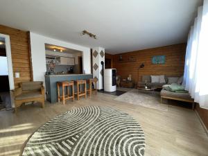 a living room with a couch and a kitchen at Waldmarie in Grafenau