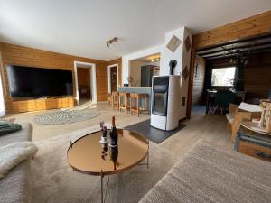 a living room with a couch and a table at Waldmarie in Grafenau +25 photos
