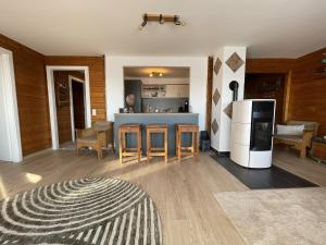 a kitchen and living room with a stove and a refrigerator at Waldmarie in Grafenau