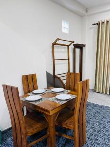 a dining room table with chairs and a wooden table at Horizon in Katunayaka