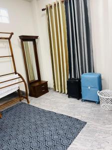 a room with a curtain and a blue suitcase at Horizon in Katunayaka