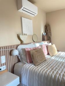 a bedroom with a bed with pillows on it at Chambre d Amis in Lokeren