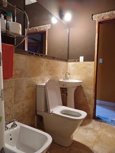 a bathroom with a toilet and a sink at Cabaña Aklla in Tilcara +5 photos