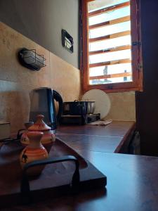 a kitchen with a stove with a pot on the counter at Cabaña Aklla in Tilcara
