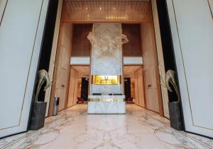 a lobby of a building with a marble floor at Modern Spaces U-Tower in Tashkent