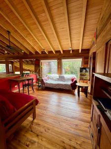 a bedroom with a bed in a room with wooden floors at Casa Arrayan in Puerto Varas