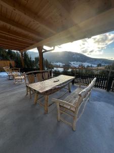a wooden table and chairs sitting on a patio at Apartment Vlasic in Šišava