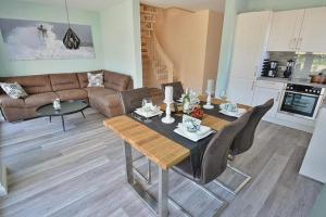 a living room with a table and a couch at Haus Fischerstraße 6a in Grömitz