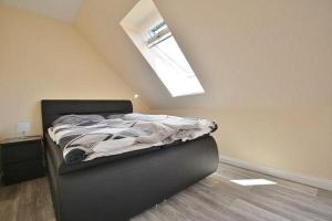 a bedroom with a bed with a skylight at Haus Fischerstraße 6a in Grömitz