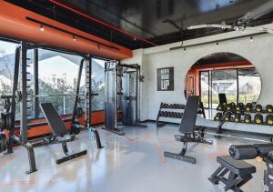 a gym with a bunch of treadmills and weights at Modern Spaces U-Tower in Tashkent