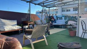 a patio with chairs and a swing on a roof at RIA Terrace in Faro