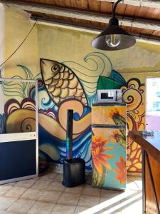 a wall with a painting of a fish on it at RIA Terrace in Faro +41 photos
