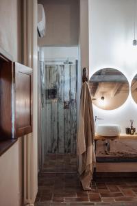 a bathroom with a sink and a shower with a mirror at Casale Tasciotto in Genazzano