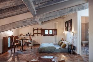 a bedroom with a bed and a table in it at Casale Tasciotto in Genazzano